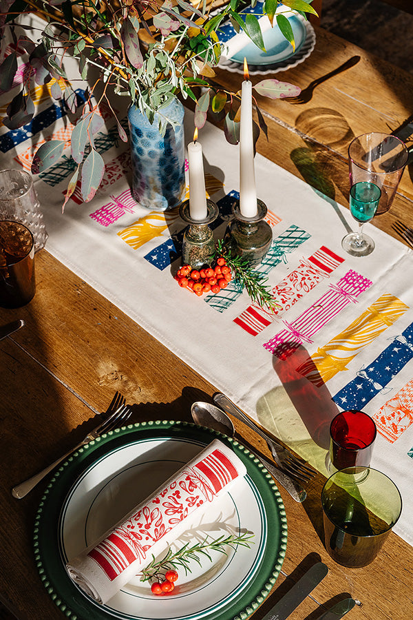 Lottie Day Christmas collection featuring red robin napkins and festive cracker-style cotton serviettes for holiday table styling