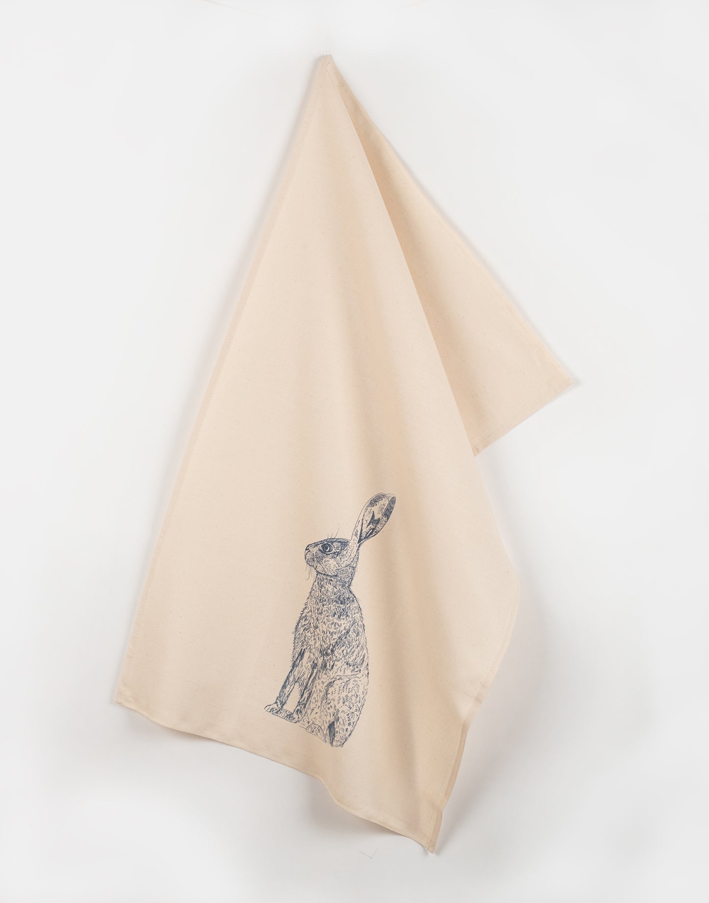 Blue Hare tea towel by Lottie Day – handmade cotton kitchen towel featuring moon-gazing hare illustration, inspired by Norfolk countryside