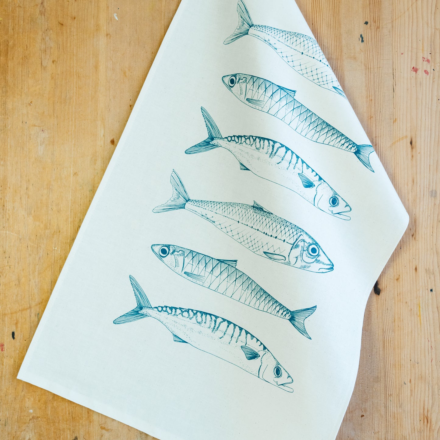 Fish tea towel by Lottie Day featuring handprinted coastal fish illustration – made from cotton and inspired by Norfolk wildlife